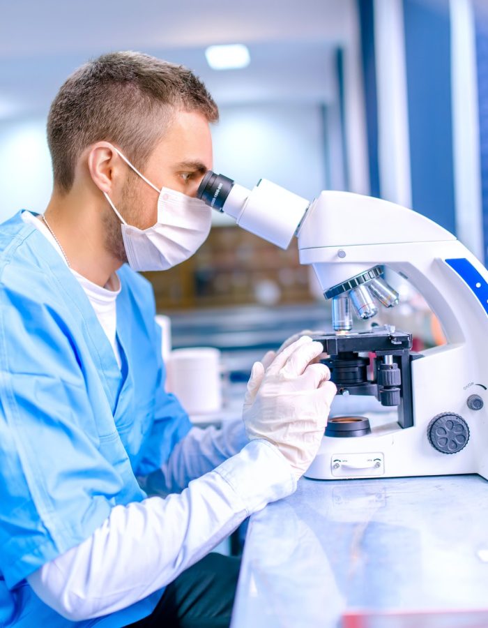 male-scientist-chemist-working-with-microscope-in-pharmaceutica.jpg male-scientist-chemist-working-with-microscope-in-pharmaceutica.jpg
